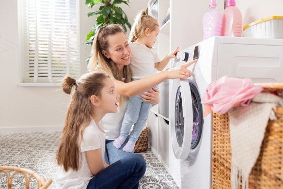 Mother and two children doing the laundry