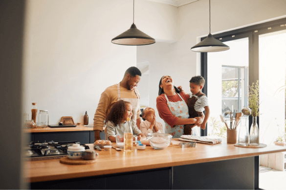 Family of 5 laughing and baking together in kitchen