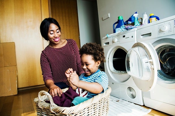 Mother and son doing laundry together 